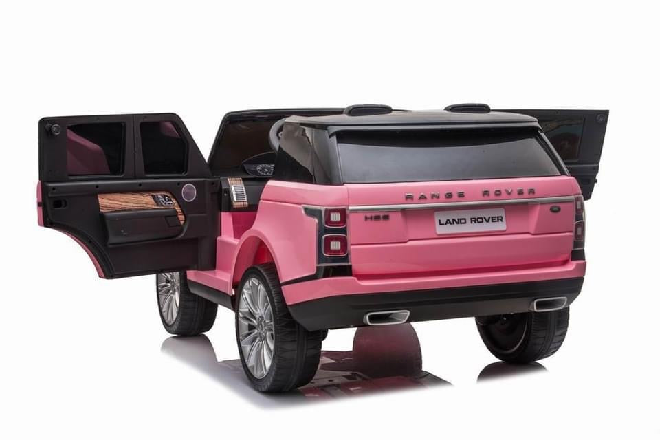 Electric pink Range Rover Vogue HSE 2 seater ride on Jeep for kids with open trunk, isolated on white background.