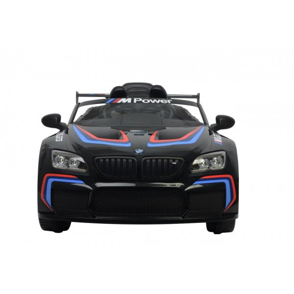 Black BMW M6 GT3 electric ride-on for kids with M power branding and coloured accents, featuring 12V power and parental remote control on a white background.