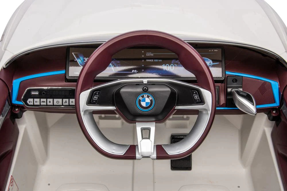 White BMW I4 electric ride on car for kids showcasing steering wheel and digital dashboard.