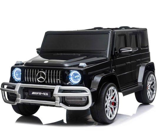 Black two-seater Mercedes G-Wagon AMG G63 electric ride-on for kids, equipped with illuminated front headlights, silver accents, and Bluetooth-enabled sound system.