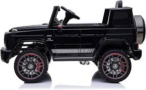 Black Mercedes Benz G63 AMG battery electric ride-on car for kids with large wheels.