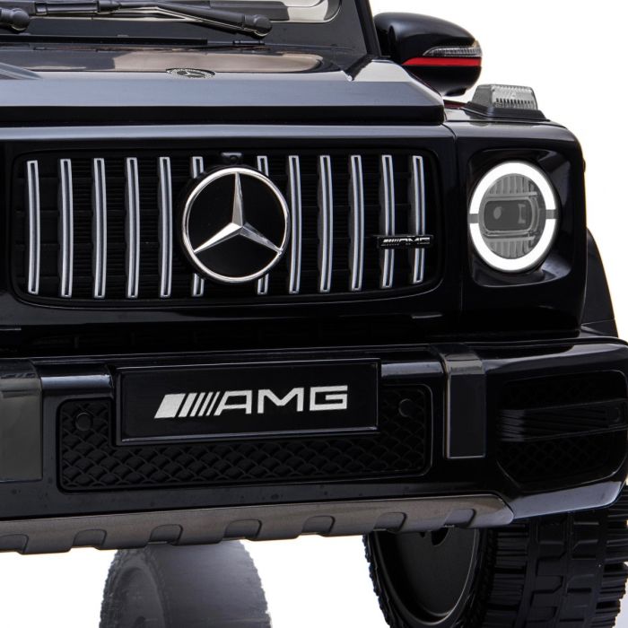 Front grille and headlight of a black Mercedes Benz G63 AMG 12V electric ride on car for kids