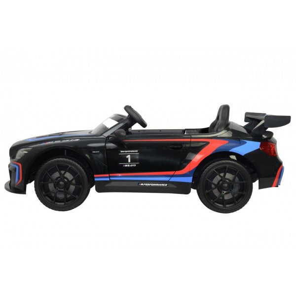 Black electric BMW M6 GT3 ride-on car for kids with blue and red racing stripes, 12 volt, featuring parental remote control on a white background.