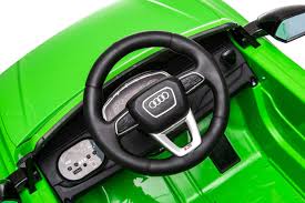 Green Audi RS Q8 12-volt electric ride-on dashboard and steering wheel for kids by Audi.