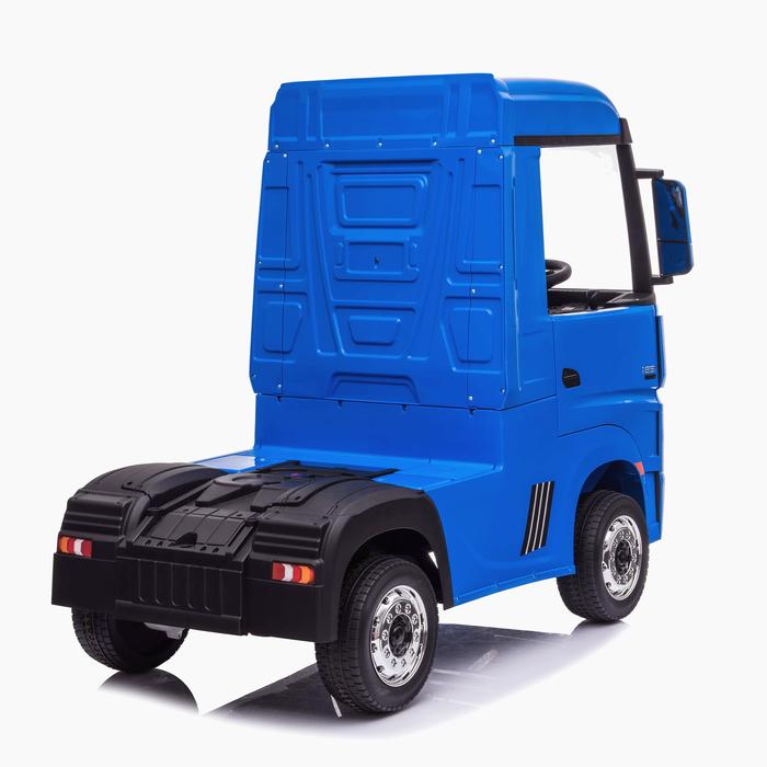 Blue and black electric Mercedes Actros children's ride-on lorries on a white backdrop