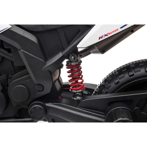 Close-up view of Aprilia 12v electric motorbike for kids with detailed image of red shock absorber and wheel