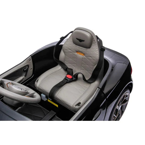 Child car seat in black Bentley Bacalar, 12 volt electric ride-on with parent remote.