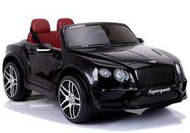 Blue Bentley Continental Supersports convertible electric ride-on toy car for children with red seats, isolated on a white background.