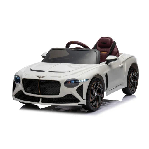 White Bentley Bacalar electric ride-on toy car with black wheels and red interior for children's play.