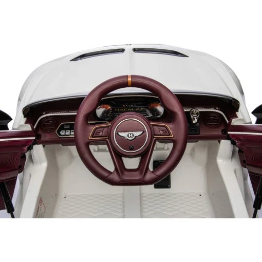Children's White Bentley Bacalar Electric Ride on Car interior with focus on steering wheel and dashboard.