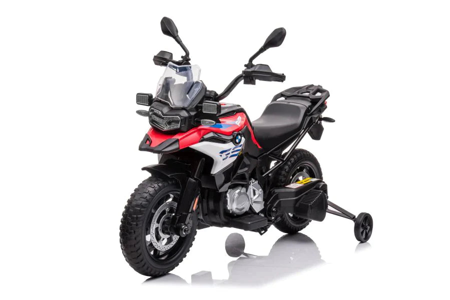 Red and black BMW electric ride-on motorbike with rubber wheels, designed for kids on a white backdrop.
