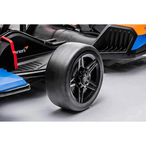 Close-up view of McLaren Electric Go Kart's 24V front wheel and aero elements for kids.