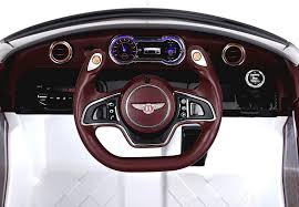 Modern steering wheel and digital dashboard of a luxury Bentley GT EXP12 children's electric ride-on car with MP3 compatibility.