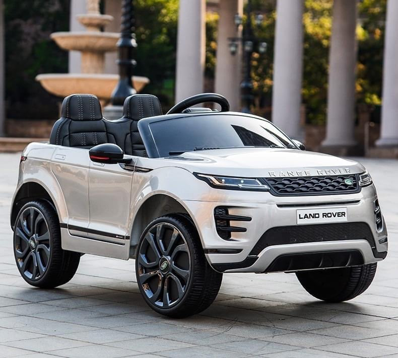 "White Range Rover Evoque kids electric ride-on car with parental control parked outdoors"