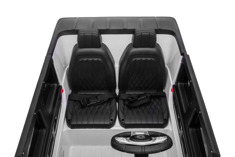 "Black and white Mercedes G-Wagon AMG G63 two-seater electric ride on jeep for kids, featuring a steering wheel and luxurious details of Mercedes-Benz."