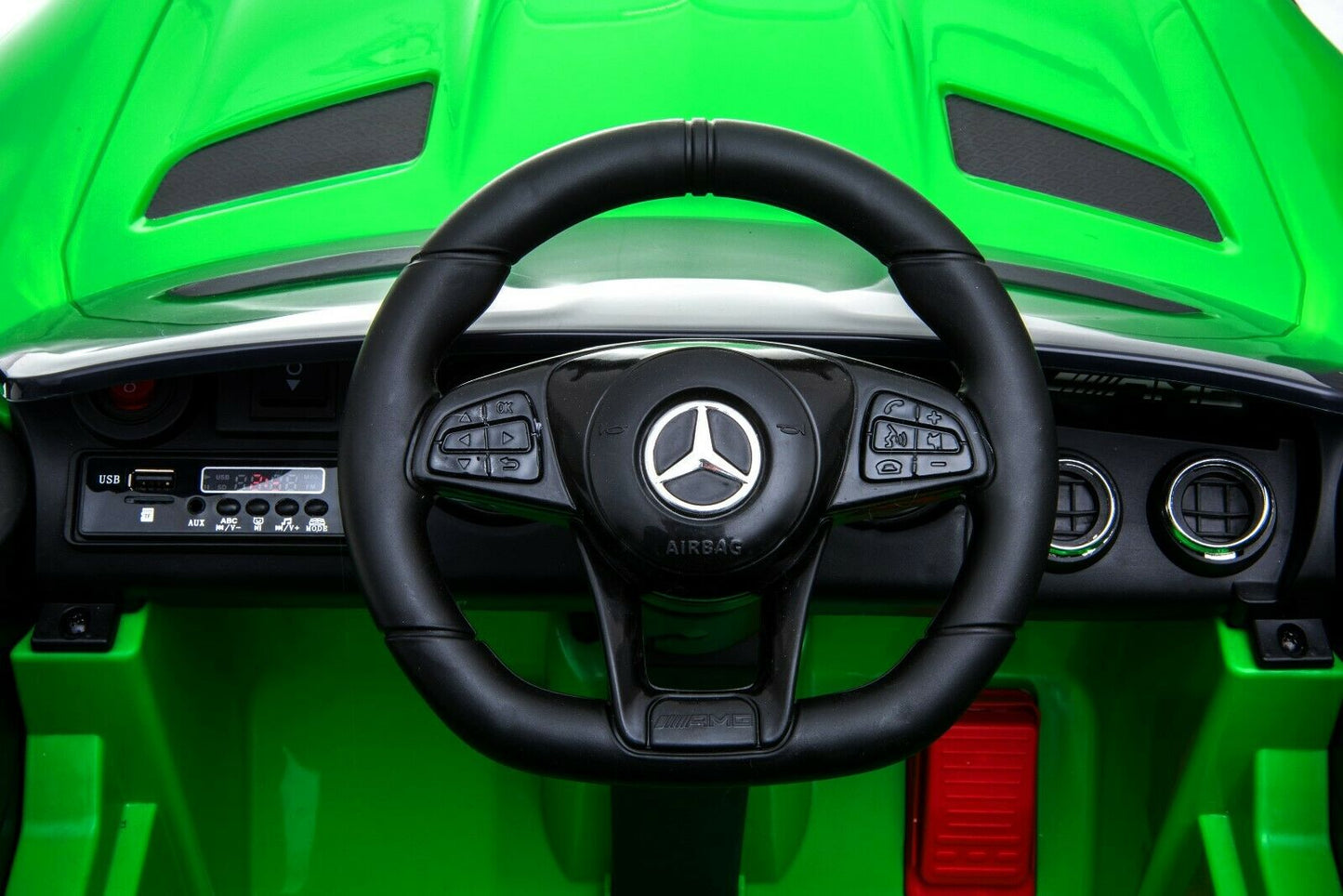 "Green Mercedes AMG GTR, 2 seater 12v, officially licensed kids ride on car with parent remote feature and steering wheel for authentic driving experience"