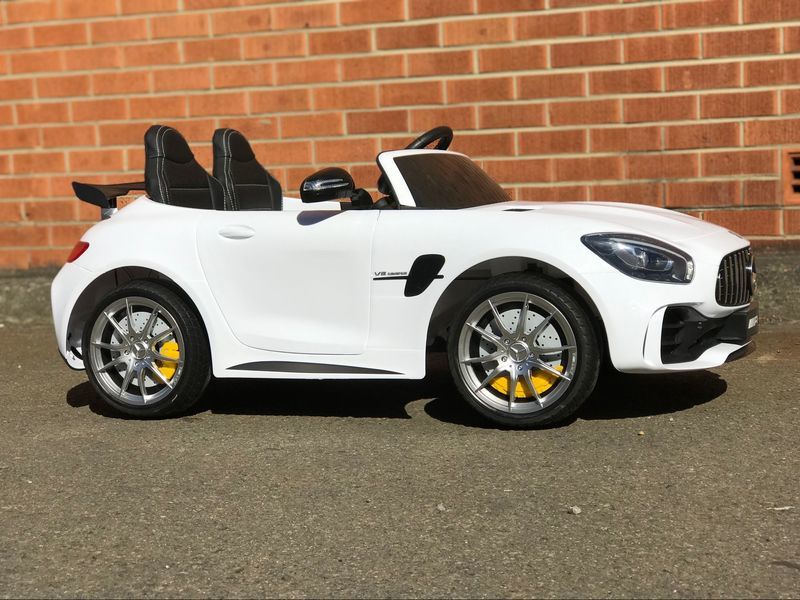 "White 24v MERCEDES AMG GTR 2-Seater with Parent Remote, displayed at Kids Car store"