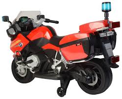 Red and black BMW R1200 electric ride on police motorcycle for kids with emergency lights and hard side cases.