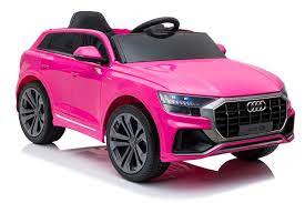 A pink, licensed Audi Q8 SUV kid's car with electric ride on feature isolated on a white background.