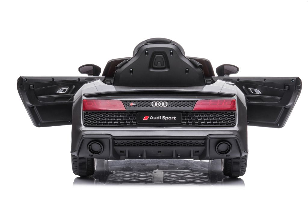 Rear view of luxe grey/silver Audi R8 licensed ride-on car for kids with open doors on a white background.