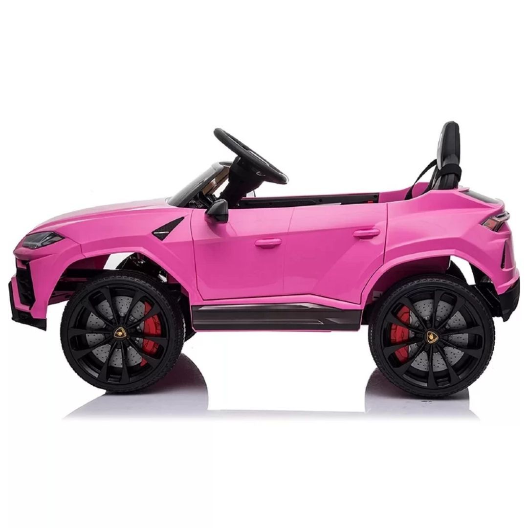 Bright pink electric Lamborghini Urus ride-on toy car with black wheels.
