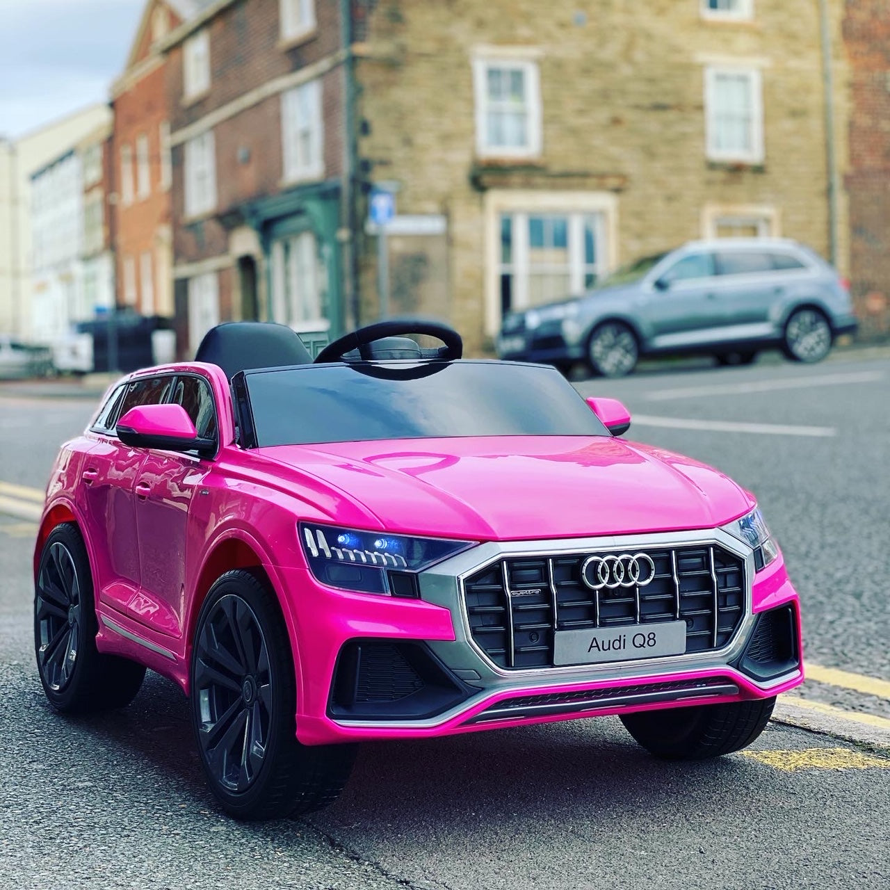 "Pink Audi Q8 SUV 12 Volt Electric Ride on Car with Parental Remote Control, Cruising Down the Street"