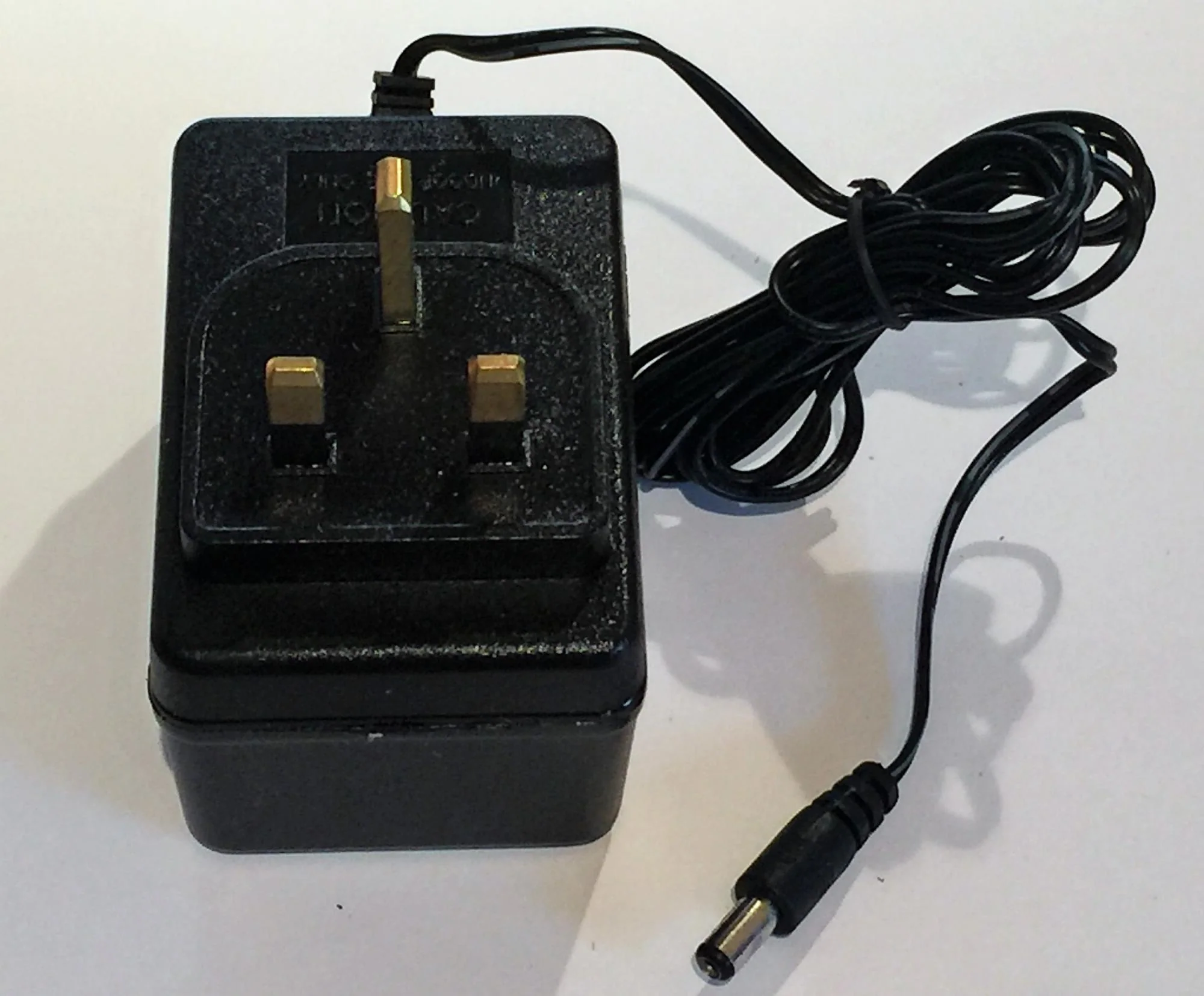 "Universal 12v Battery Charger for Children's Ride-On Car, Motorbikes and Quad ATV, with a black ac adapter and cord."