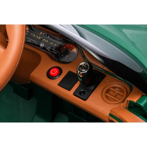 Close-up view of Blue Bentley Bacalar 12V Electric Ride-On car's dashboard featuring start-stop button, gear shift, and analog clock