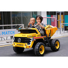 Two children enjoying outdoor playtime on a 12V, two-seater, electric Construction Truck ride-on toy.