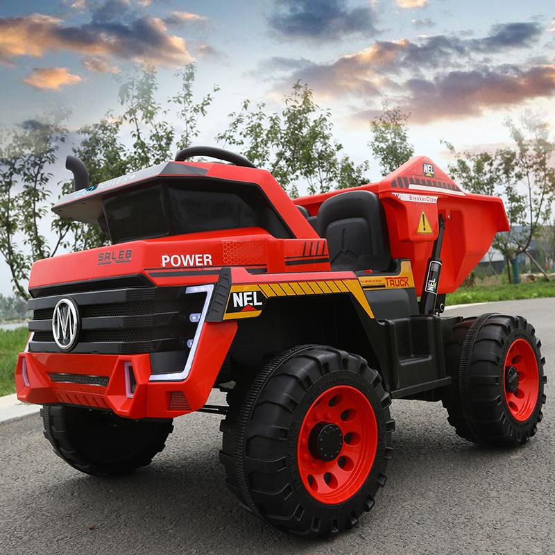 Two-seater red and black electric ride on construction truck for kids with oversized wheels.