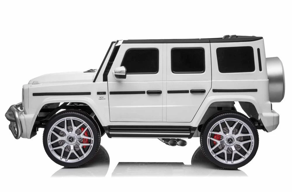 A White Mercedes G-Wagon AMG G63 2-seater kids car with electric ride-on and 4-wheel drive feature, displayed against a white backdrop.