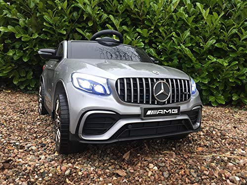 "Silver Mercedes GLC 63S AMG toy car for kids parked on gravel driveway"