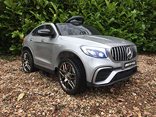 "Silver Metallic Mercedes GLC 63S AMG Children's Electric Ride On Car parked on gravel"
