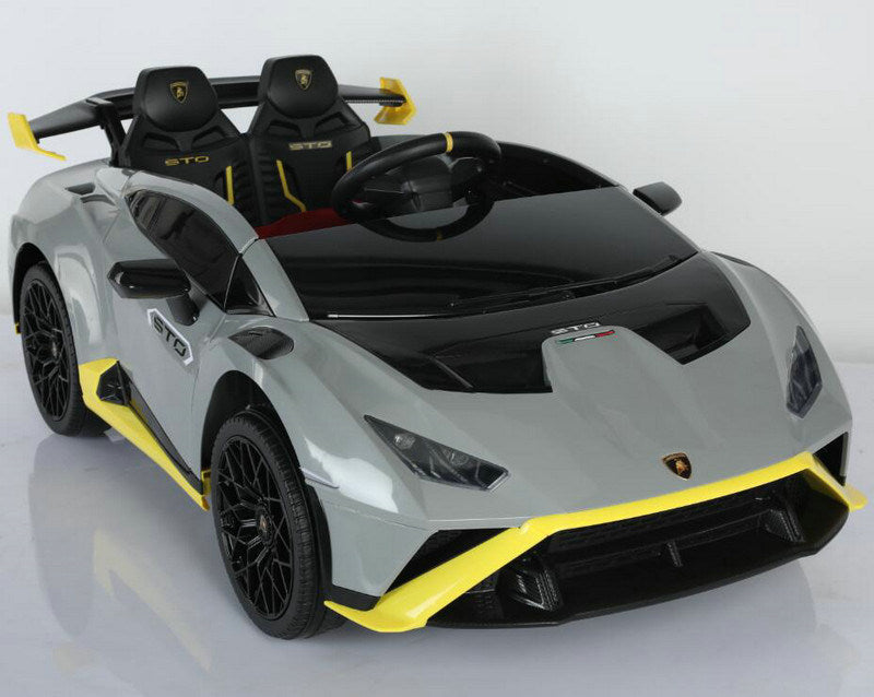 Two-tone Lamborghini Huracan STO inspired ride-on car with open top and remote control for children.