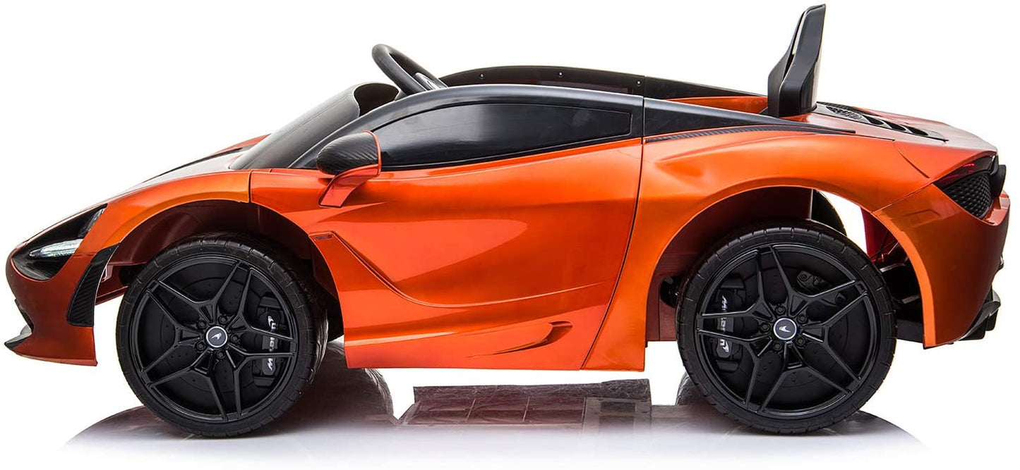 Side view of an orange, battery-operated McLaren sports ride on with open door, isolated on a white background.