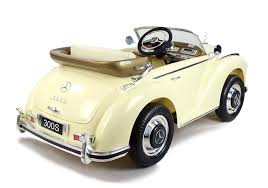 Vintage cream-colored Mercedes Benz 300S electric ride on car for kids set against a white background.