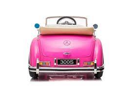 Rear view of pink Mercedes-Benz 300S electric ride on car for kids with white wall tires