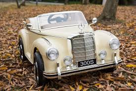 Vintage Mercedes-Benz 300S toy car for kids on a bed of autumn leaves