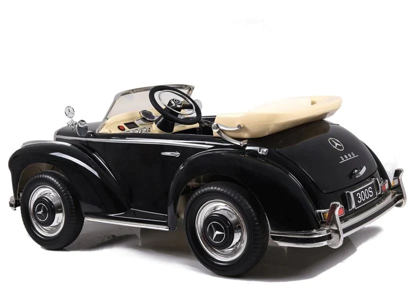 Vintage black Mercedes Benz 300S kids electric car with surfboard attachment