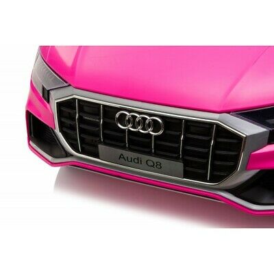 Pink Audi styled 12V electric ride on for children against a white backdrop.