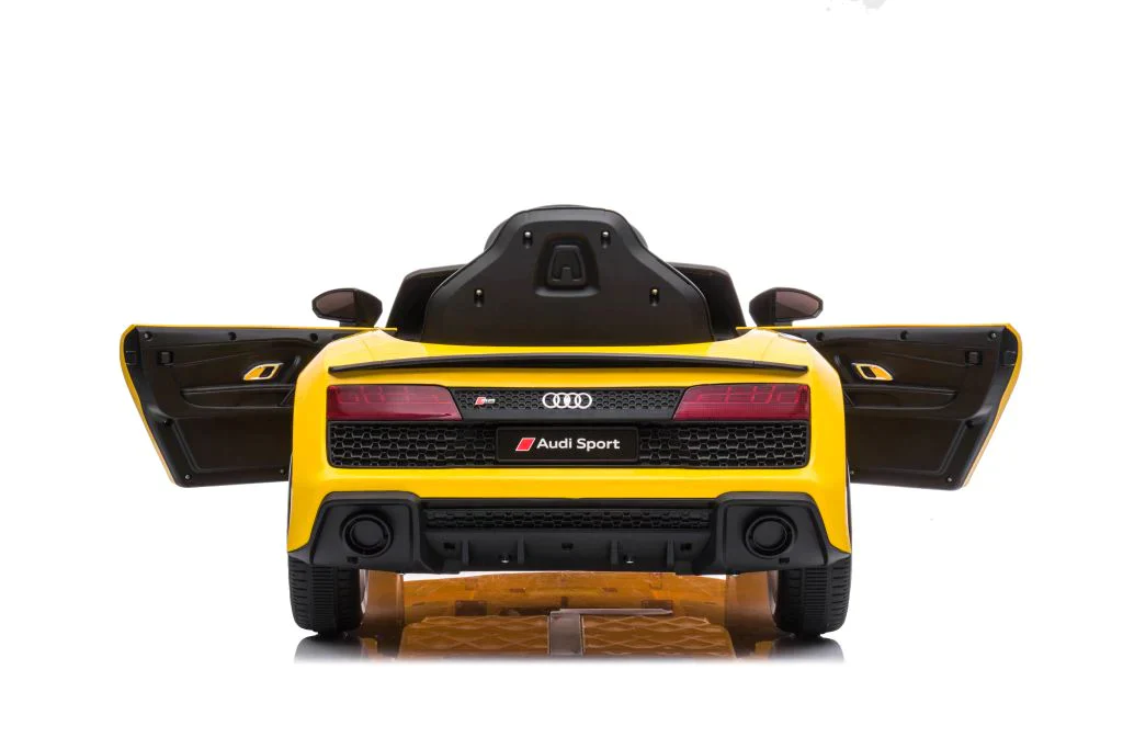 Yellow Audi R8 children's electric ride-on car with extended rear wing on white background.