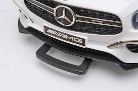 Close-up of white toy car's front grille and AMG badge, modeled after Mercedes SL63 Electric ride-on for children.