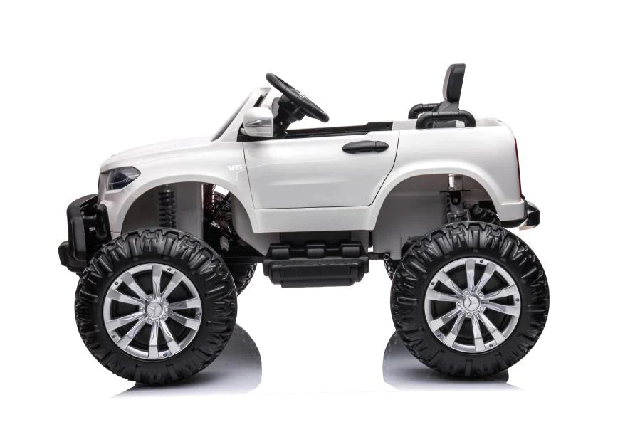 White Mercedes monster truck electric ride-on for kids with oversized wheels on a white background